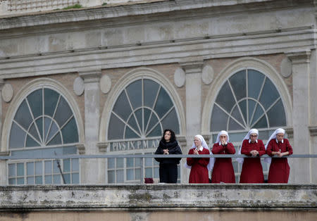 Nuns pray as Pope Francis delivers his Easter message in the Urbi et Orbi (to the city and the world) address from the balcony overlooking St. Peter's Square at the Vatican April 1, 2018. REUTERS/Max Rossi