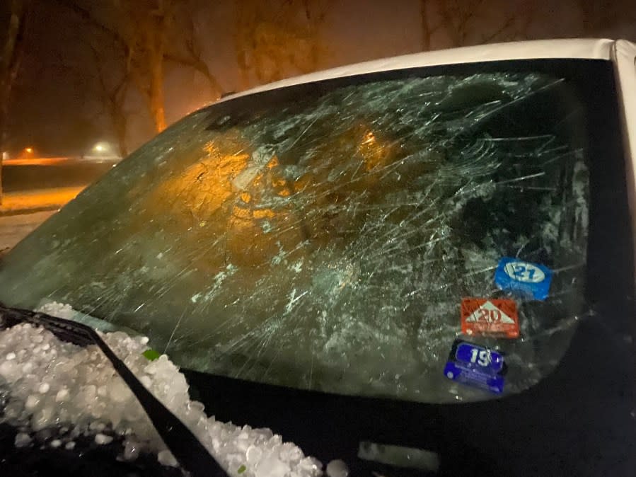 A white Ford F-150 windshield is destroyed by hail