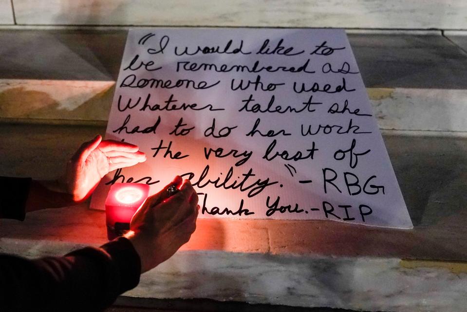 People light candies outside the Supreme Court.