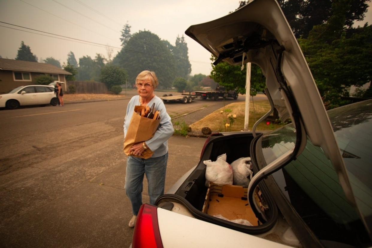 Patty Beard and neighbors pack their cars Friday afternoon in Oakridge. People in Oakridge spent time on Friday preparing themselves and their homes for lack of power and possible wildfires and evacuations. The greater Oakridge-Westfir area was evacuated Friday evening and the area is closed the public.