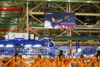 A large 777X banner is seen hanging over the Boeing 777X Final Assembly Building floor during a media tour of Boeing production facilities in Everett