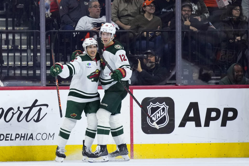 Minnesota Wild's Matt Boldy, right, and Jared Spurgeon celebrate after Boldy's goal during the second period of an NHL hockey game against the Philadelphia Flyers, Thursday, March 23, 2023, in Philadelphia. (AP Photo/Matt Slocum)