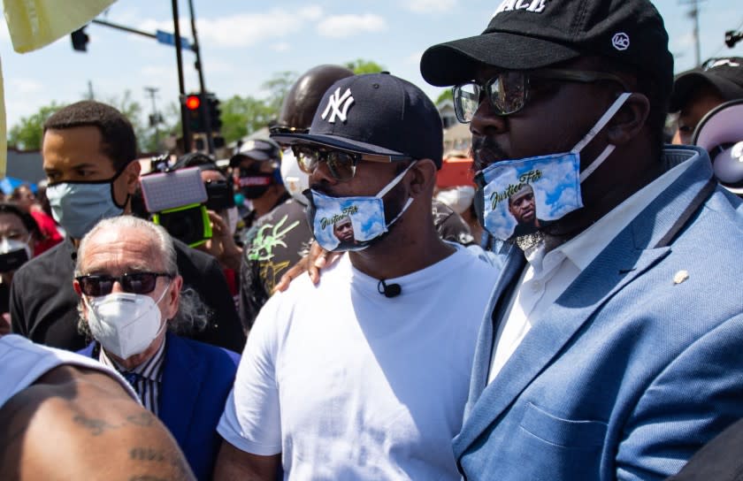 MINNEAPOLIS , MINNESOTA - JUNE 01: Terrence Floyd (center) pays their respects at the makeshift memorial outside Cup Foods where his brother George Floyd was murdered by a Minneapolis police officer on Monday, June 1, 2020 in Minneapolis , Minnesota. Terrence is joined by his lawyer Sanford Rubenstein (left) and Rev. Kevin McCall (right) (Jason Armond / Los Angeles Times)