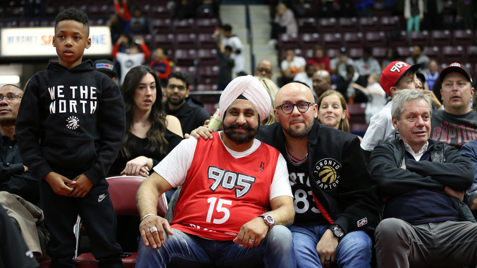 Toronto Raptors superfan Nav Bhatia sitting courtside.