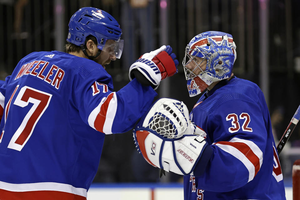 New York Rangers right wing Blake Wheeler (17) congratulates Jonathan Quick after the Rangers defeated the Detroit Red Wings in an NHL hockey game Tuesday, Nov. 7, 2023, in New York. The Rangers won 5-3. (AP Photo/Adam Hunger)