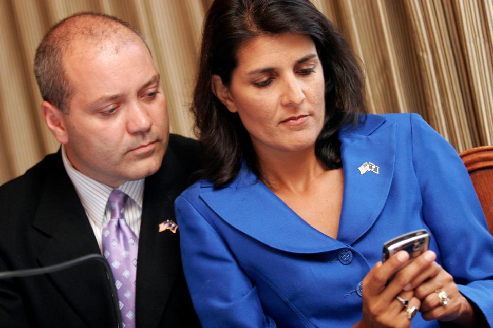Nikki Haley and husband Michael Haley look at a phone