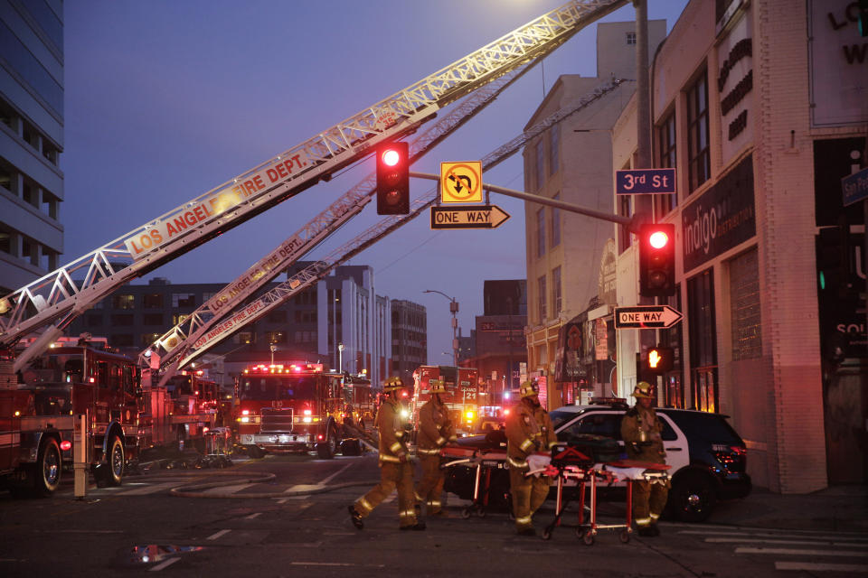 FILE - Los Angeles Fire Department firefighters work the scene of a structure fire that injured multiple firefighters, May 16, 2020. The owner of a downtown Los Angeles building where an explosion injured 12 firefighters has been allowed to enter a judicial diversion program that allows him to avoid jail time. A court commissioner on Wednesday, March 30, 2022, granted Steve Sungho Lee's request to enter the two-year program. (AP Photo/Damian Dovarganes, File)