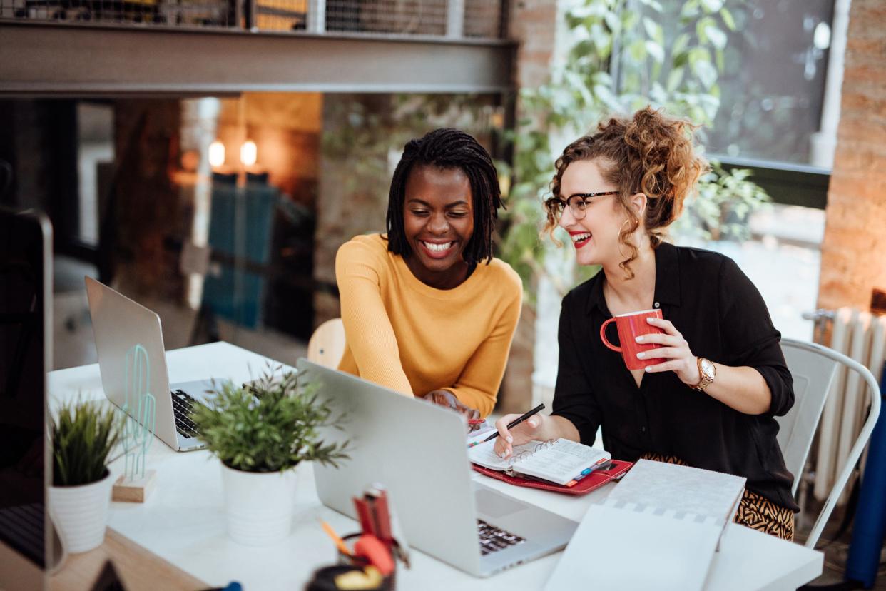 two women working together in snazzy office