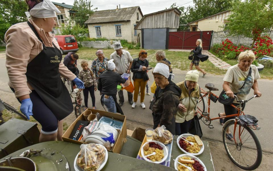 People receive food as a humanitarian aid in Novoselivka village, Chernihiv region, Ukraine - OLEG PETRASYUK/EPA-EFE/Shutterstock