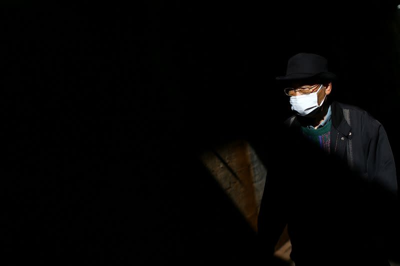 A man, wearing protective face mask following the outbreak of the coronavirus disease (COVID-19), is pictured in Tokyo