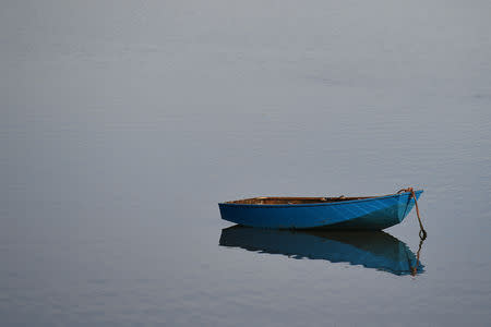 A boat floats on low tide in the marshland at Sunderland Point, Britain February 25, 2019. REUTERS/Clodagh Kilcoyne