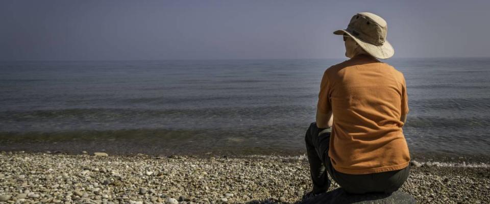 A woman on the beach watching Lake Michigan