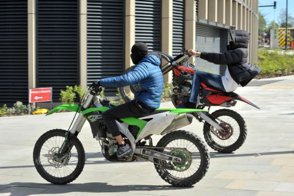 Bradford Telegraph and Argus: One of the men pulls a wheelie on the bike after crossing Godwin Street