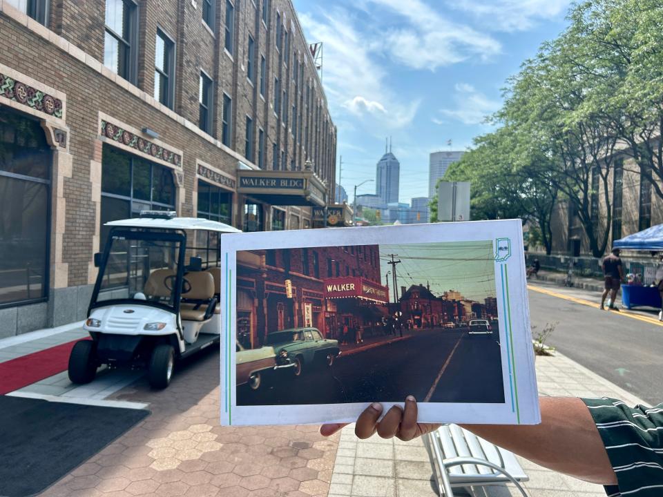 Sampson Levingston holds a photo of historic Indiana Avenue to compare it to the present-day landscape. Levingston has been giving tours of Indianapolis since the summer of 2020.