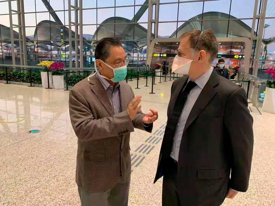 In this Jan. 29, 2020, photo provided by Ian Lipkin, Lipkin, right, director of the Center for Infection and Immunity at Columbia University, meets with Zhong Nanshan at the airport in Guangzhou, China.