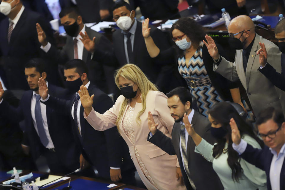 New members of the New Ideas party are sworn in during the Legislative Assembly in San Salvador, El Salvador, Saturday, May 1, 2021. (AP Photo/Salvador Melendez)