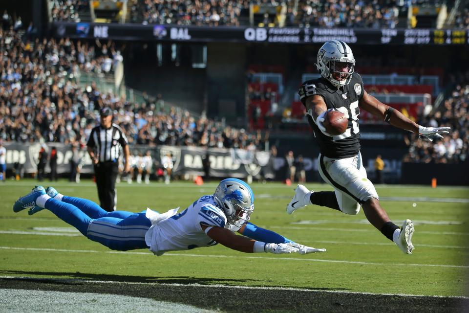 Raiders running back Josh Jacobs runs for a touchdown past Lions defensive back Miles Killebrew during the first half in Oakland, Calif., Sunday, Nov. 3, 2019.