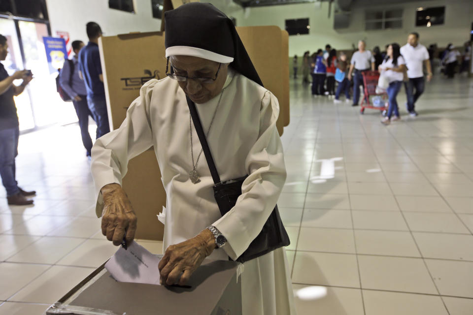 Nun Zoila Hernandez casts her vote during the presidential election at a polling station in San Salvador, El Salvador, Sunday, Feb. 3, 2019. Salvadorans are choosing from among a handful of presidential candidates all promising to end corruption, stamp out gang violence and create more jobs in the Central American nation. (AP Photo/Moises Castillo)