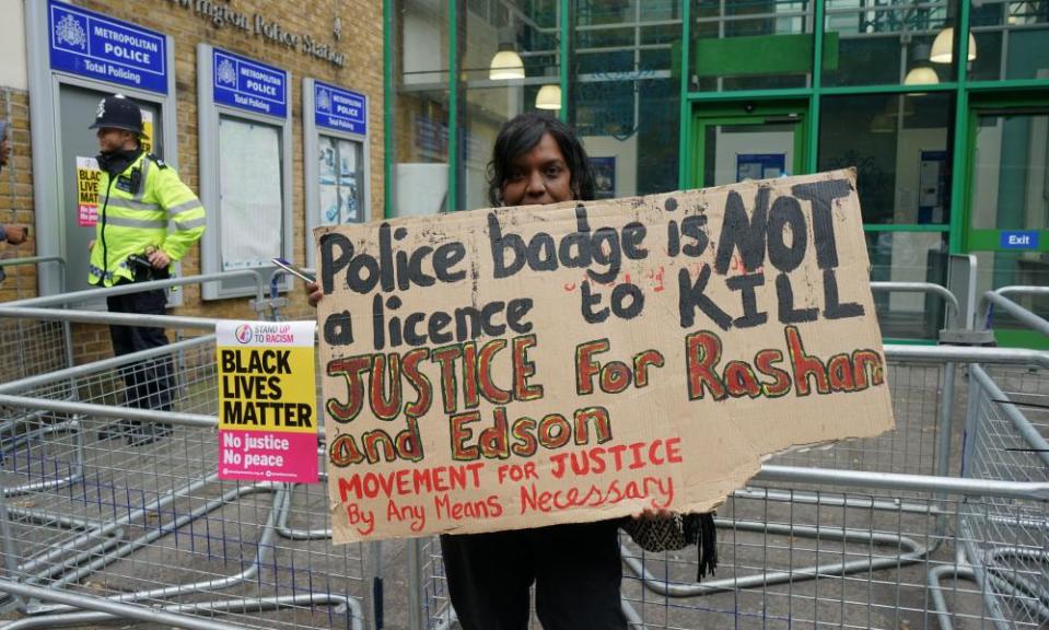 A member of the Movement for Justice group outside Stoke Newington police station in July 2017 to protest over the deaths of Edson Da Costa and 20-year-old Rashan Charles.