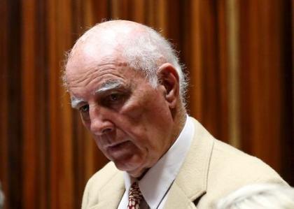 Former Grand Slam doubles champion Bob Hewitt looks on ahead of court proceedings at the South Gauteng High Court in Johannesburg February 10, 2015. REUTERS/Siphiwe Sibeko