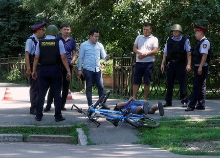 Police officers detain a man after an attack in the centre of Almaty, Kazakhstan, July 18, 2016. REUTERS/Shamil Zhumatov