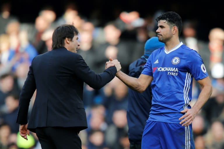Chelsea's head coach Antonio Conte (L) embraces Chelsea's striker Diego Costa (R) during the English Premier League football match against Arsenal February 4, 2017