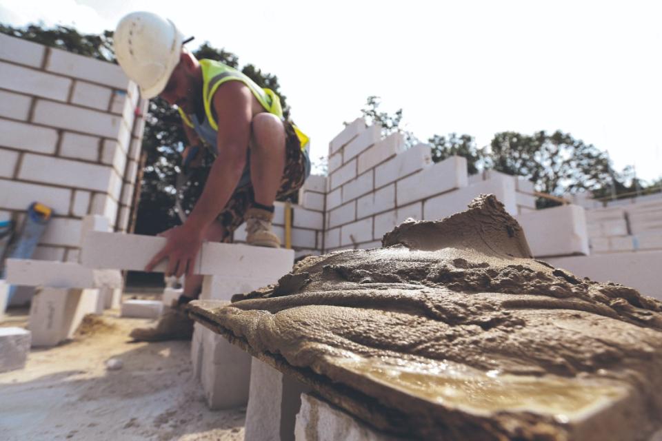 Crest rejected a bid from Bellway. Here a construction worker cuts a breeze block brick to size for a new home under construction at a Crest Nicholson Holdings  residential housing development Photographer: Chris Ratcliffe/Bloomberg via Getty Images