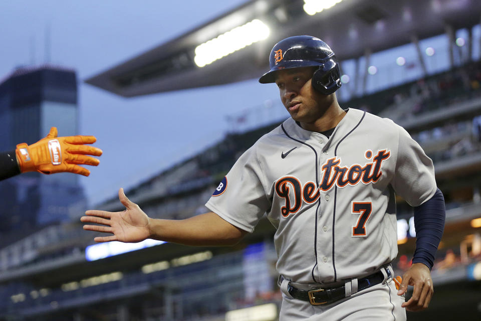 Detroit Tigers' Jonathan Schoop celebrates with a teammate after scoring against the Minnesota Twins in the seventh inning of a baseball game Monday, May 23, 2022, in Minneapolis. (AP Photo/Andy Clayton-King)