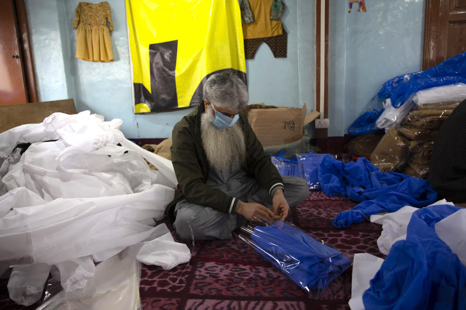 Kashmiri volunteer packs disposable protective suit to be distributed free among different hospitals in Srinagar Indian controlled Kashmir, Friday, April 3, 2020. (AP Photo/ Dar Yasin)