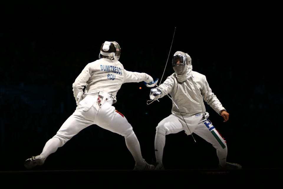 LONDON, ENGLAND - JULY 29: Nikolay Kovalev (R) of Russia competes against Rares Dumitrescu of Romania in the Men's Sabre Individual on Day 2 of the London 2012 Olympic Games at ExCeL on July 29, 2012 in London, England. (Photo by Quinn Rooney/Getty Images)