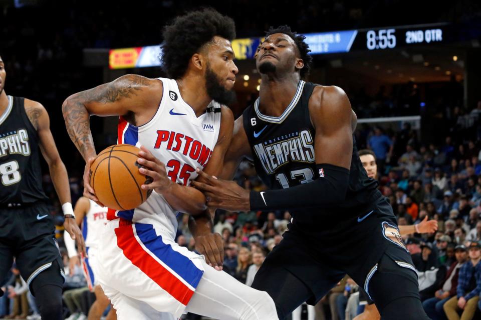 Pistons forward Marvin Bagley III drives to the basket as Grizzlies forward Jaren Jackson Jr. defends during the first half of the Pistons' 114-103 loss on Friday, Dec. 9, 2022, in Memphis, Tennessee.