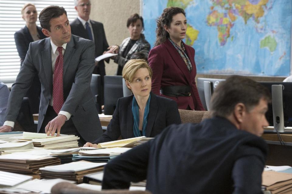 This image released by Dreamworks Pictures shows Laura Linney as Deputy Undersecretary of State Sarah Shaw, center, in a scene from "The Fifth Estate." (AP Photo/Dreamworks Pictures, Frank Connor)