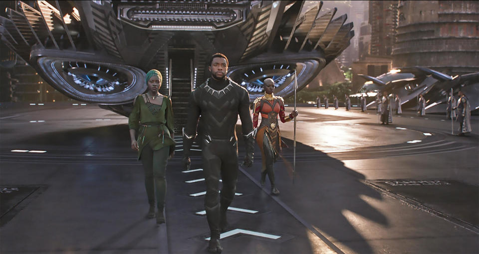 T’Challa (Chadwick Boseman, center), Nakia (Lupita Nyong’o, left), and Okoye (Danai Gurira) exiting the Royal Talon Fighter in the Ryan Coogler-directed film Black Panther.