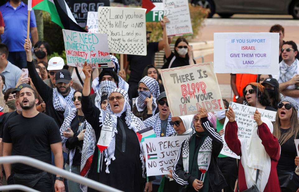 Pro-Palestinian supporters hold up signs during a demonstration at Orlando City Hall, Friday, Oct. 20, 2023, in Orlando, Fla. About 300 gathered to hear remarks critical of the Israel and the Biden administration's response to the Oct. 7, Hamas attack that sparked the current Israel–Hamas war.