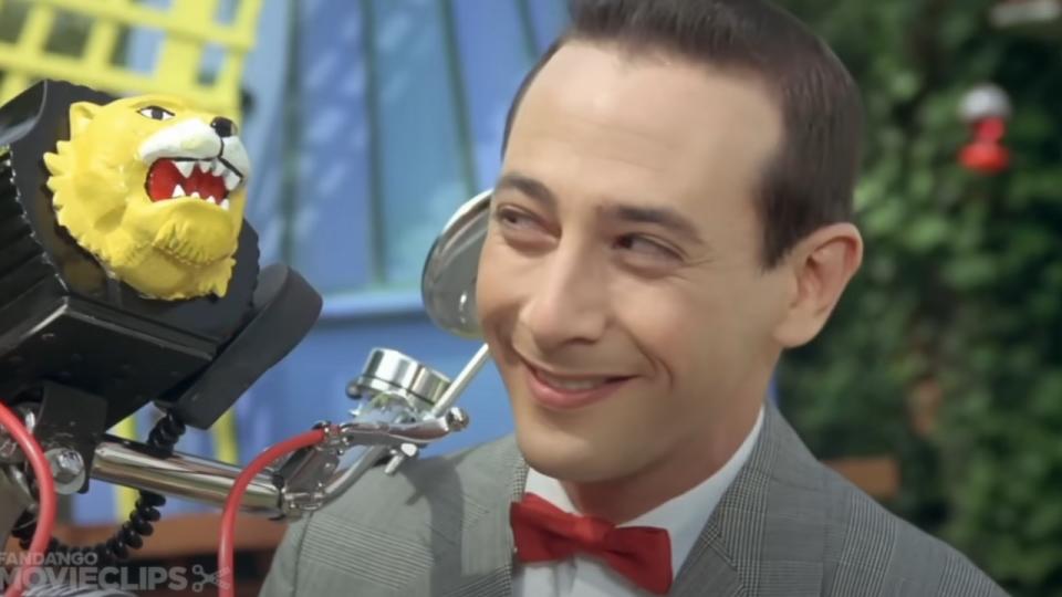 Pee-Wee Herman smiling at his bike in Pee-Wee's Big Adventure