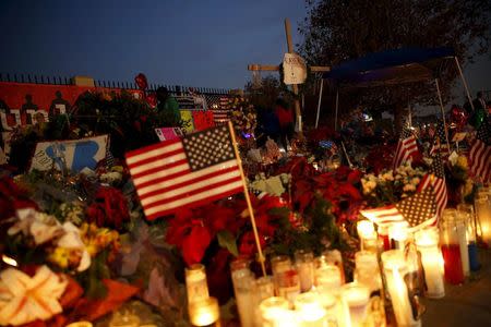 Flowers and candles are displayed at a makeshift memorial after last week's shooting in San Bernardino, California December 10, 2015. REUTERS/Patrick T. Fallon