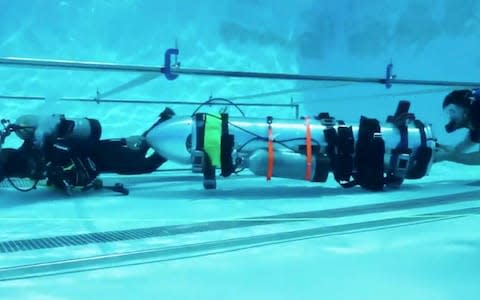 A "tiny kid-sized submarine" produced by Elon Musk's Space X rocket company being tested in a swimming pool in California   - Credit: AP