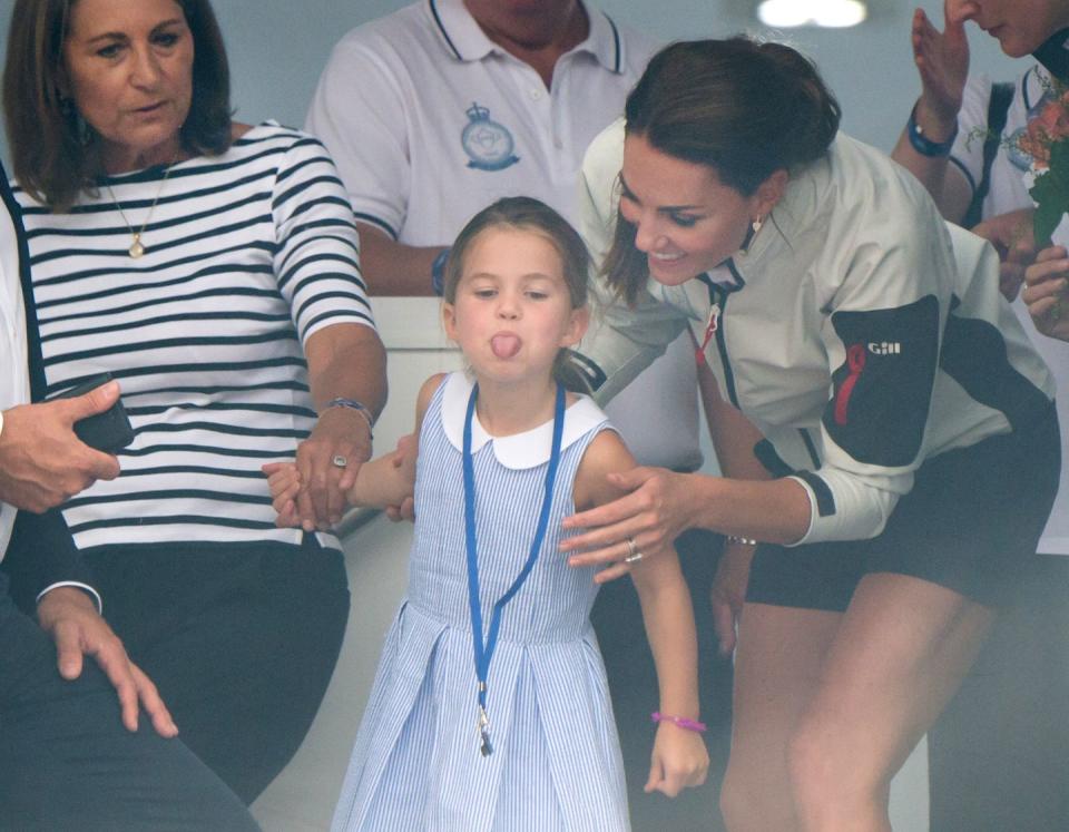 Princess Charlotte sticks her tongue out at onlookers.