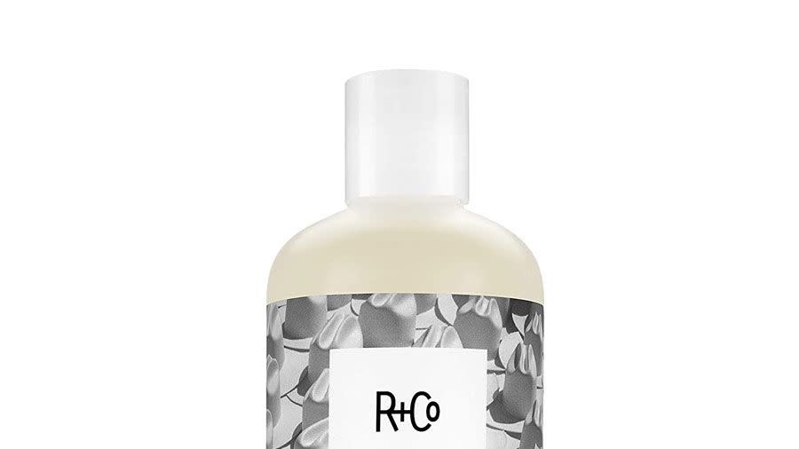 A bottle of R+Co Dallas Biotin Thickening Shampoo