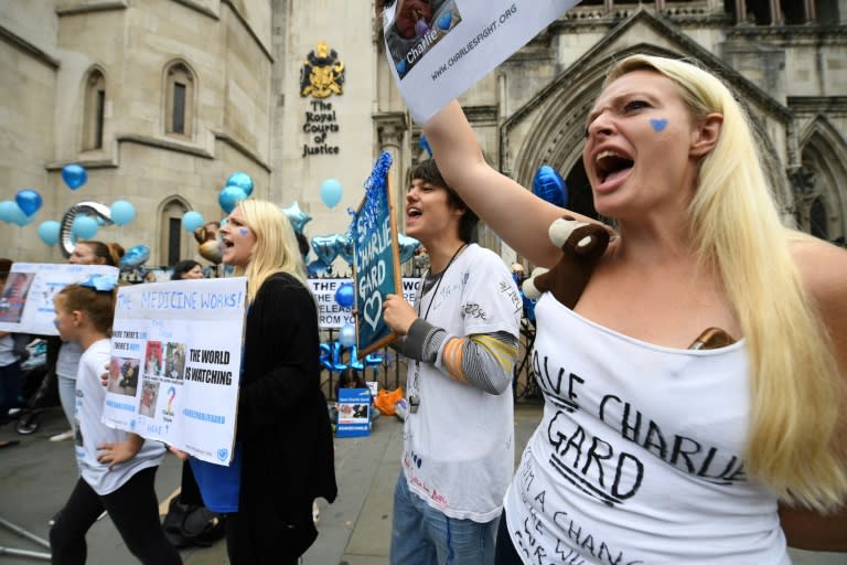 Supporters of the family of British baby Charlie Gard hold placards and signs of support outside the Royal Courts of Justice in London on July 24, 2017