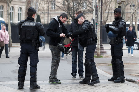 French gendarmes check people on the Champs-Elysees avenue during the Act XIX (the 19th consecutive national protest on a Saturday) of the "yellow vests" movement in Paris, France, March 23, 2019. REUTERS/Benoit Tessier