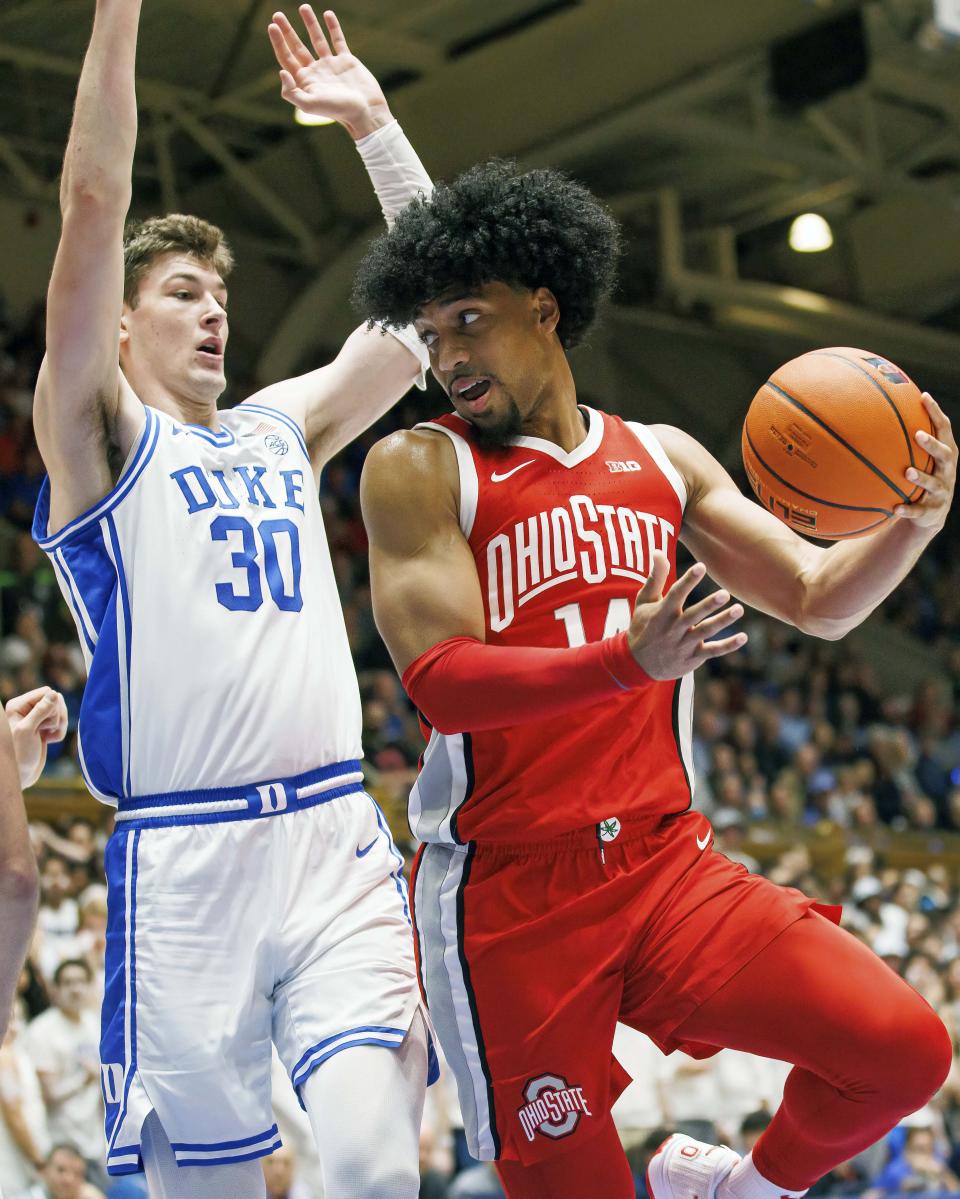 Ohio State's Justice Sueing (14) looks to pass as Duke's Kyle Filipowski (30) defends during the first half of an NCAA college basketball game in Durham, N.C., Wednesday, Nov. 30, 2022. (AP Photo/Ben McKeown)