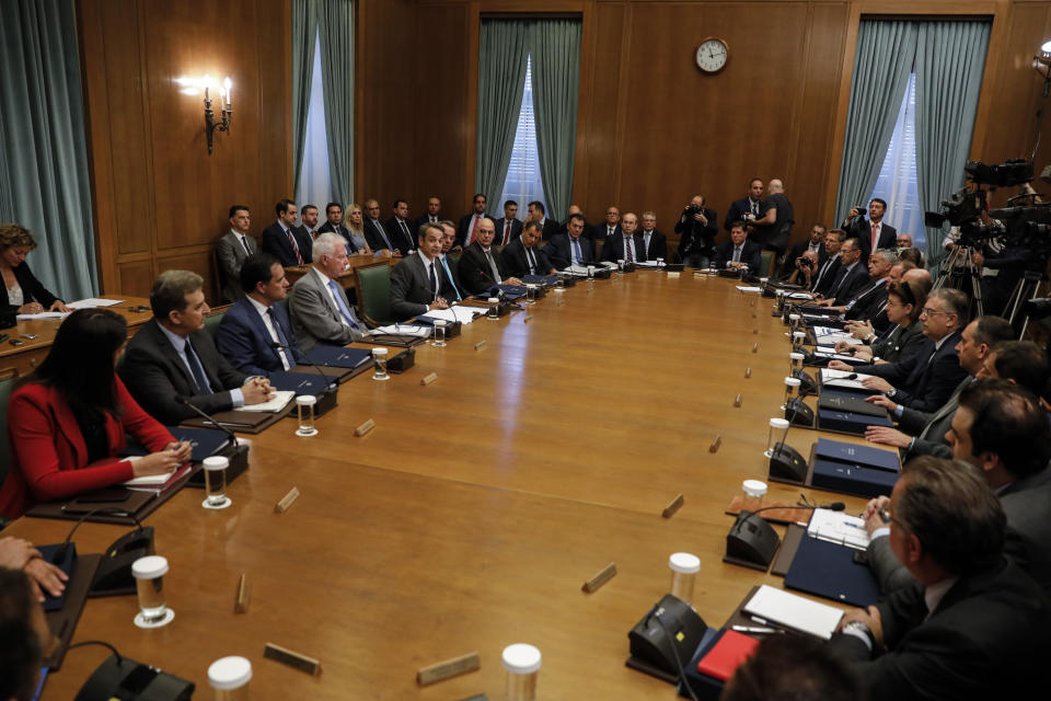 Greece's new government participate in the first cabinet meeting in Athens, Wednesday, July 10, 2019. Conservative party leader Kyriakos Mitsotakis won Sunday's election on pledges that included making the country more businesses-friendly, cutting taxes and negotiating an easing of draconian budget conditions agreed as part of the country's rescue program. (AP Photo/Petros Giannakouris)