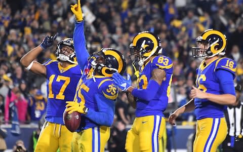 Los Angeles Rams running back C.J. Anderson (35) celebrates with wide receiver Josh Reynolds (83) and wide receiver Robert Woods (17) and quarterback Jared Goff (16) after scoring a touchdown against the Dallas Cowboys in second quarter in a NFC Divisional playoff football game at Los Angeles Memorial Coliseum - Credit: USA TODAY