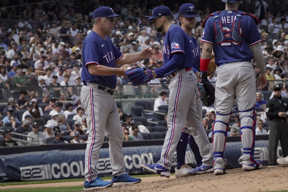 Texas Rangers manager Bruce Bochy, left, relieves pitcher Nathan Eovaldi during the sixth inning of a baseball game against the New York Yankees, Sunday, June 25, 2023, in New York. (AP Photo/Bebeto Matthews)