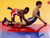 Artur Suleymanov of the Russian Federation competes against Jason Afrikaner of Namibia in the Men's Greco Roman 58kg Wrestling competition on day one of the Youth Olympics at the International Convention Centre on August 15, 2010 in Singapore. (Mark Dadswell/Getty Images)