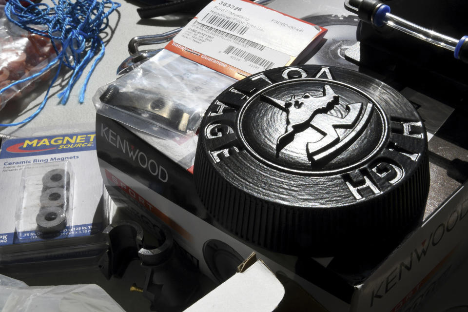 A 3D-printed gas cap replacement for an electrified 1965 Ford Mustang is seen at Inspire EV's garage in Arvada, Colo., on Sept. 23, 2022. A small but expanding group of tinkerers, racers, engineers, and entrepreneurs across the country are converting vintage cars and trucks into greener, often much faster, electric vehicles. (AP Photo/Thomas Peipert)