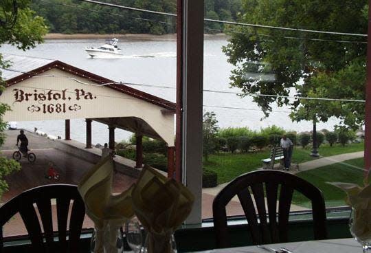 The view of the former ferry boat landing from the main dining room at the 339-year-old King George II Inn in Bristol.