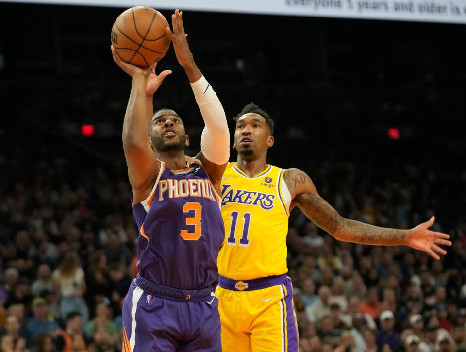 Apr 5, 2022; Phoenix, Arizona, United States; Phoenix Suns guard Chris Paul (3) shoots against Los Angeles Lakers guard Malik Monk (11) during the first quarter at Footprint Center.