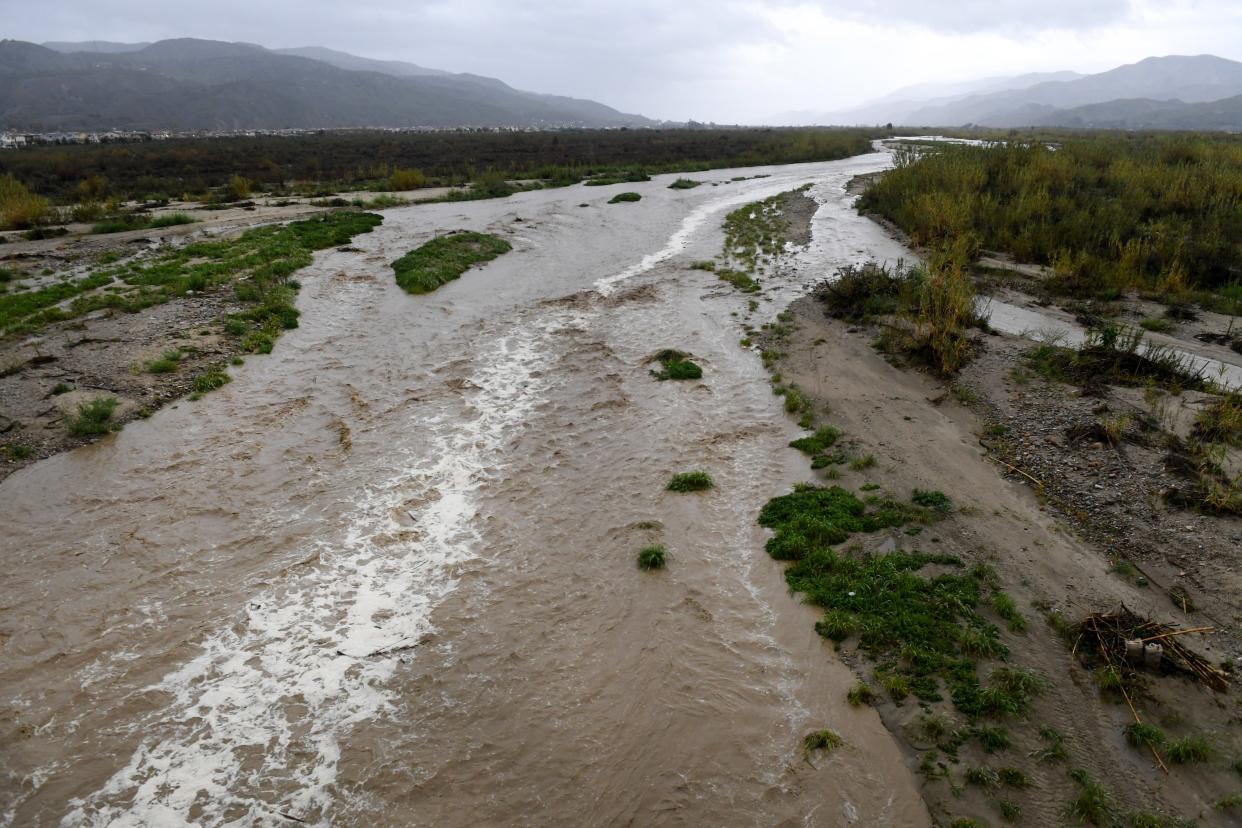 The Santa Clara River swells near Fillmore as rain fell across Ventura County Thursday. A much larger storm moving in late Saturday could bring heavy rain on Sunday into Monday.
